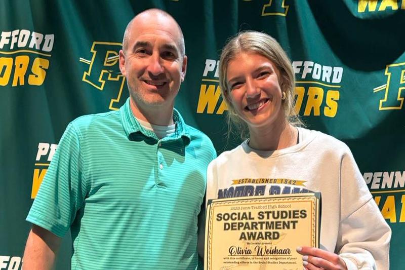 Social Studies teacher Mr. Matt Bilinsky presents the department award to Olivia Weishaar