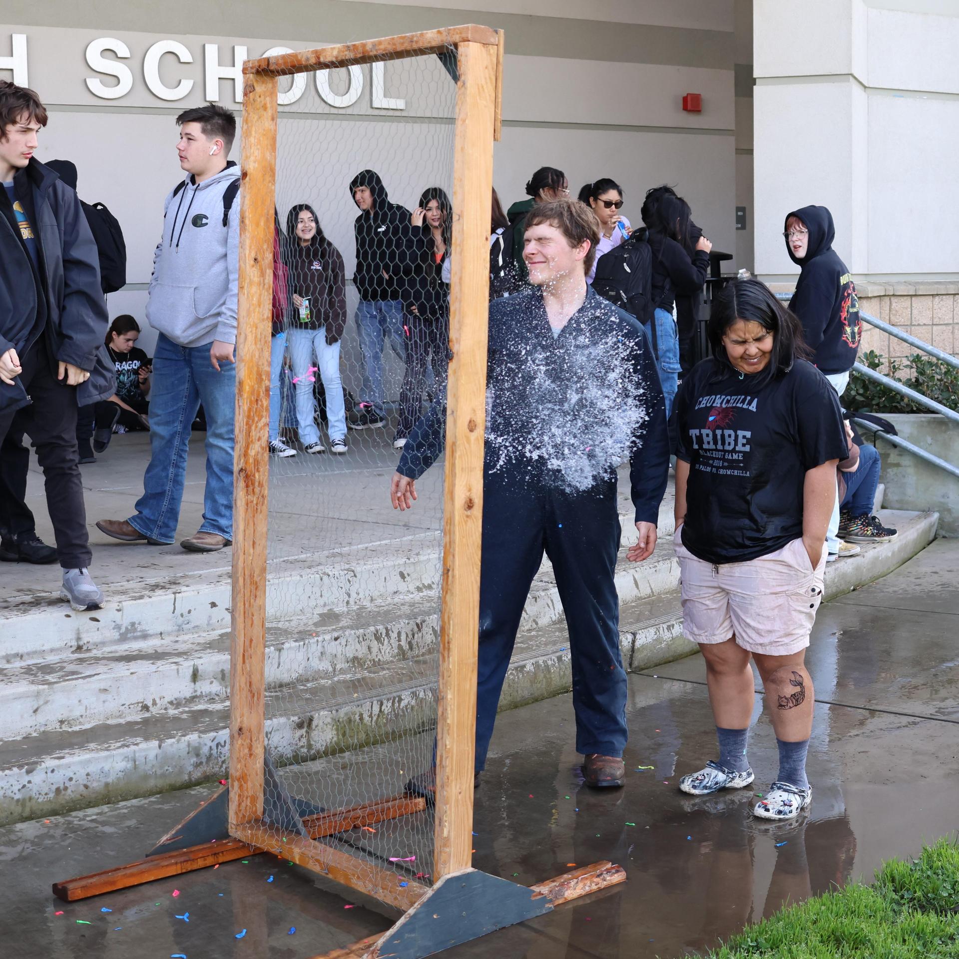 students and staff enjoying the water balloon toss
