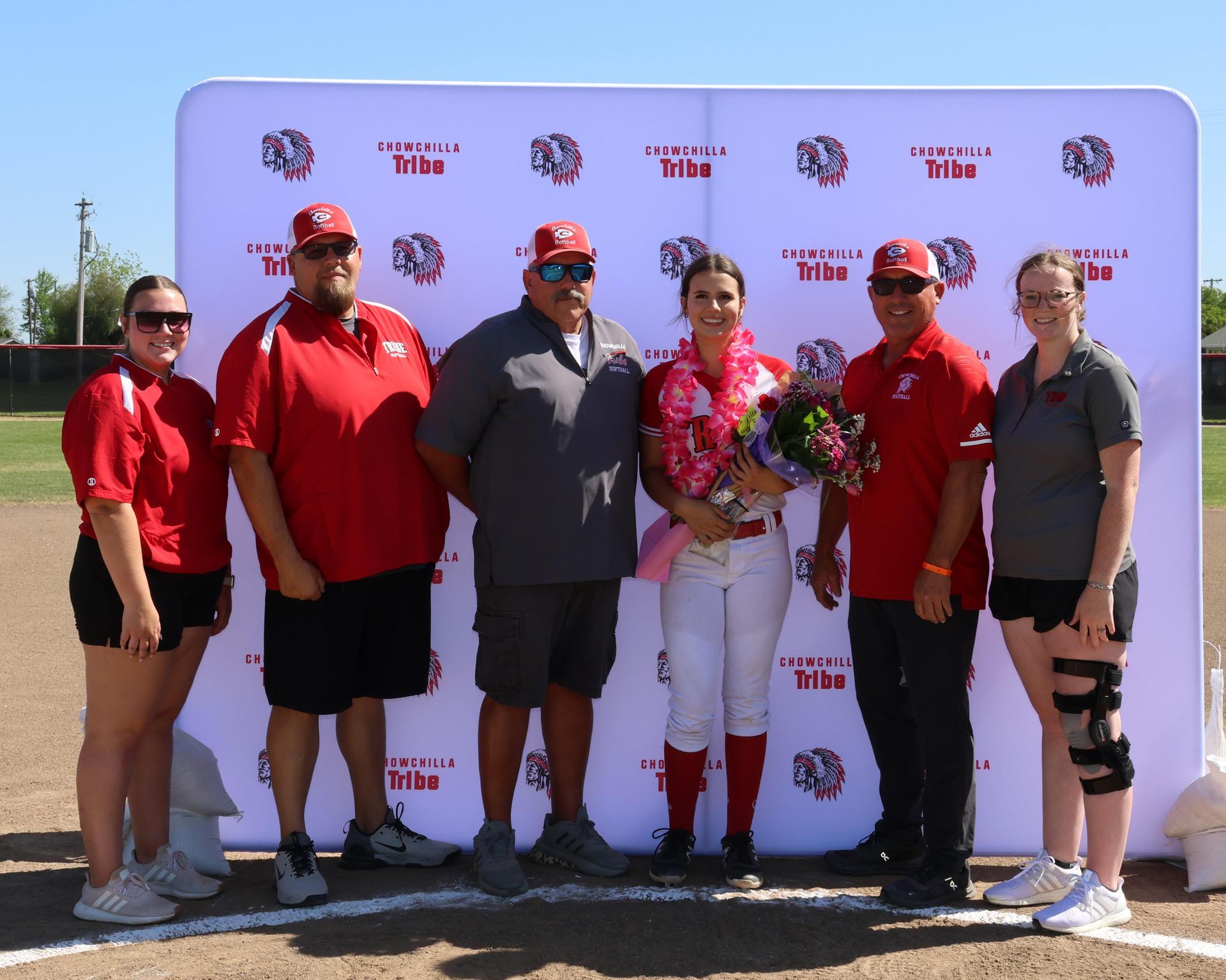 Seniors Posing With Teammates, Coaches, And Family