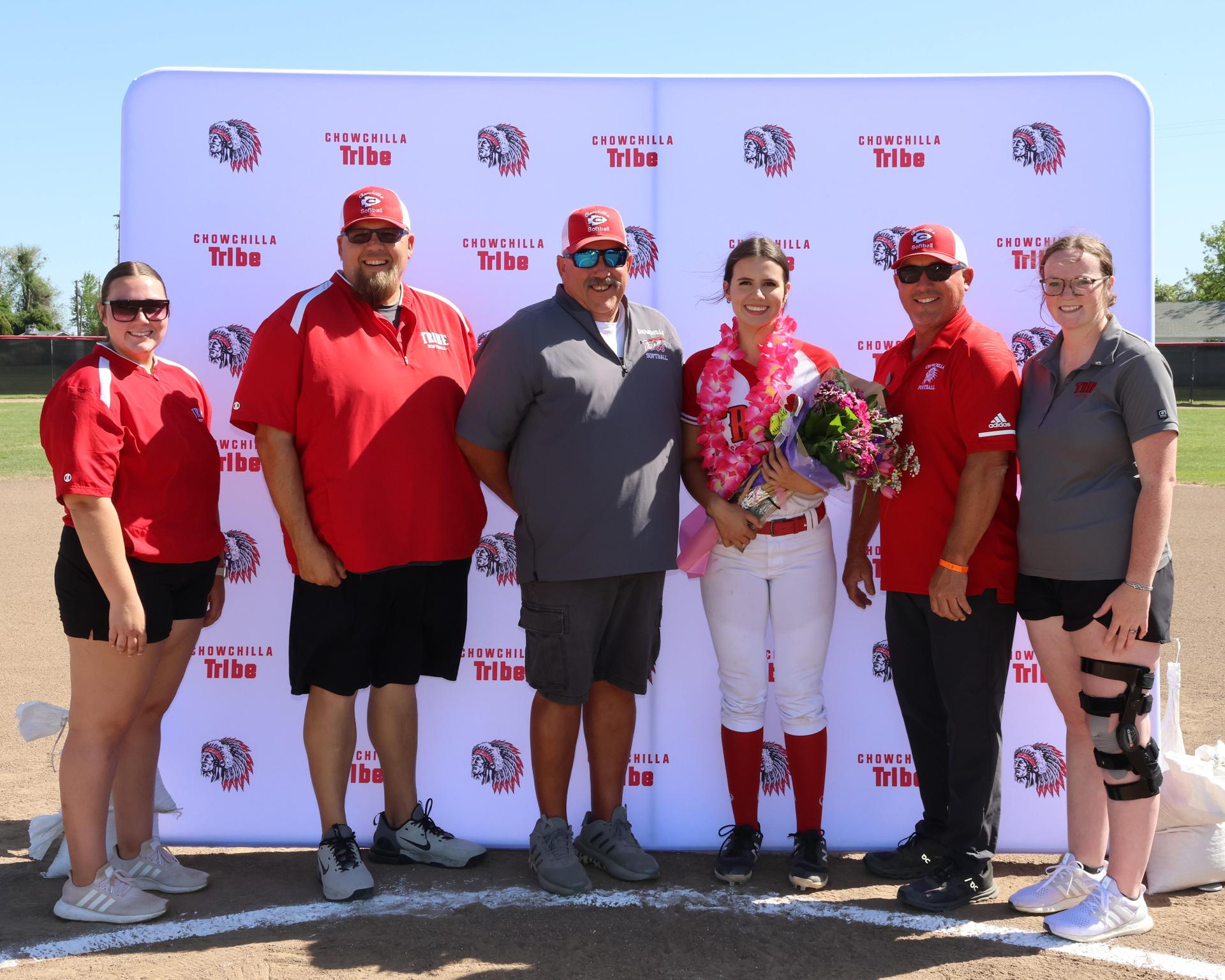Seniors Posing With Teammates, Coaches, And Family