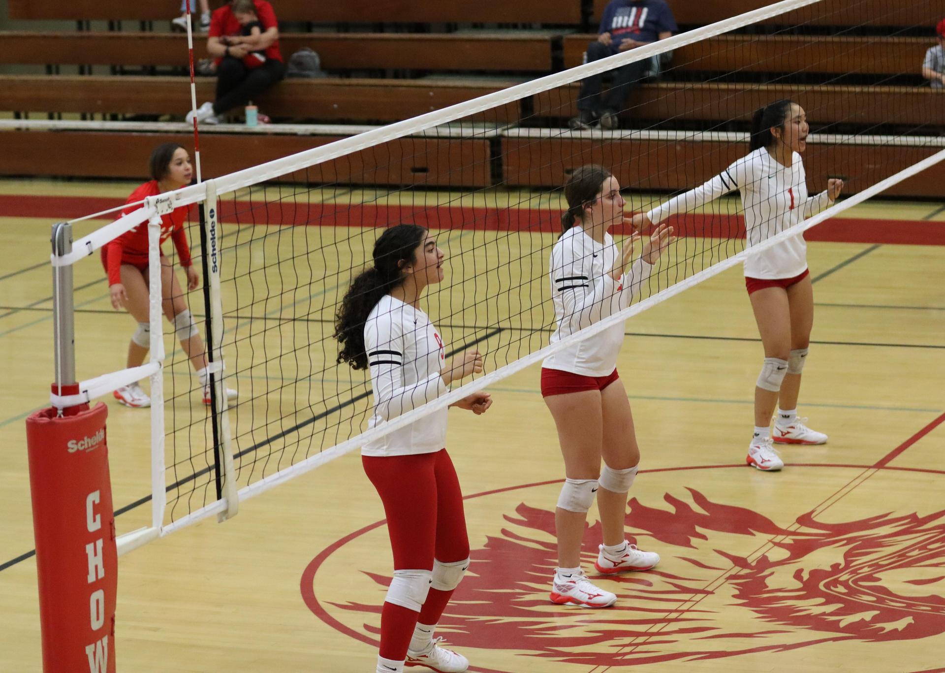 varsity volleyball players in action against liberty