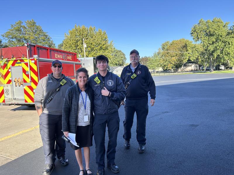 Locust Principal Mrs. Lopez stands with members of the Marengo Fire Department