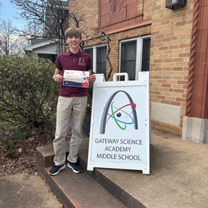 Matthew Nehre holding his reward certificate
