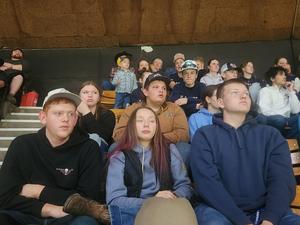 FFA members sitting together in the stands of the stadium watching the rodeo.