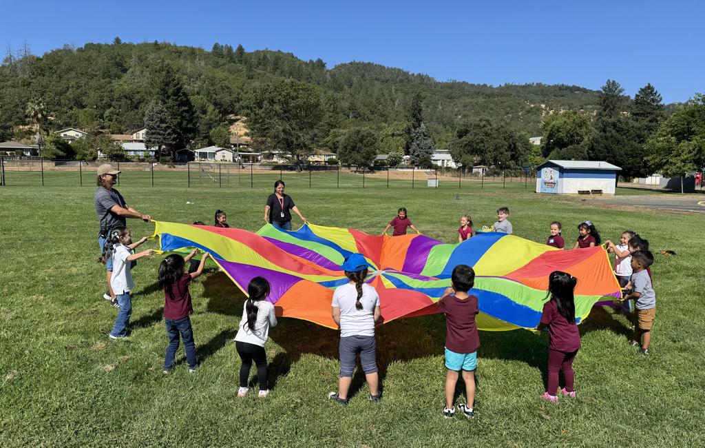 Students playing the parachute