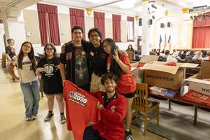 students in the auditorium for event with shirt