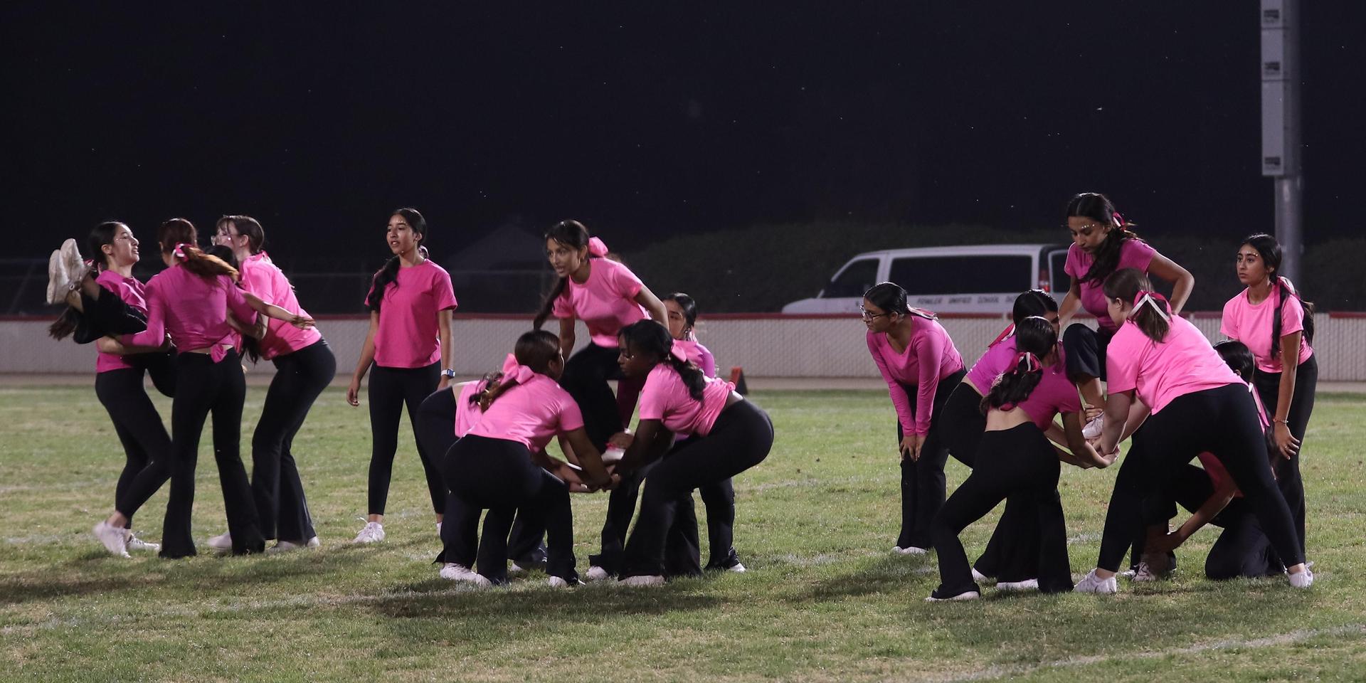Varsity Cheer performing at halftime vs. Fowler