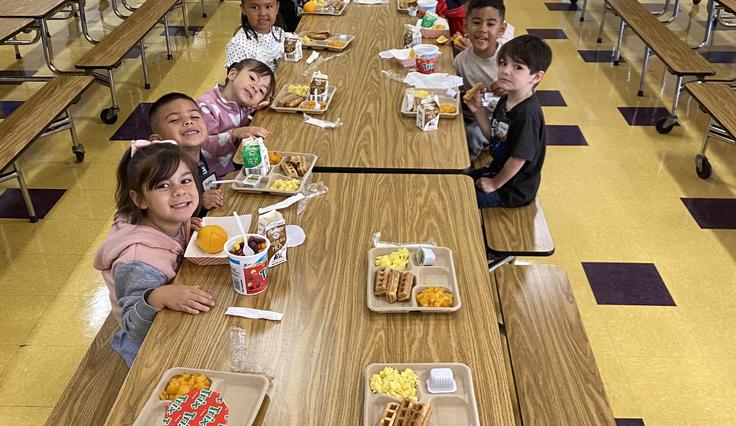 Students in the cafeteria eating breakfast.