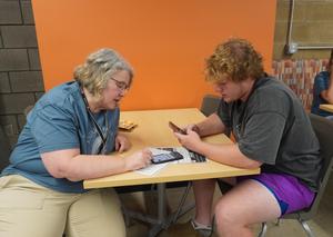 TKHS teacher Joyce Zimmer meets with her student athlete.