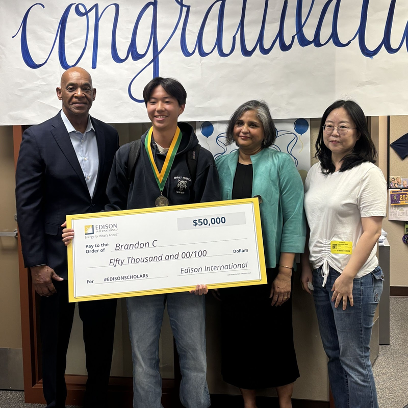 Brandon Chang poses with Edison representatives and school leadership