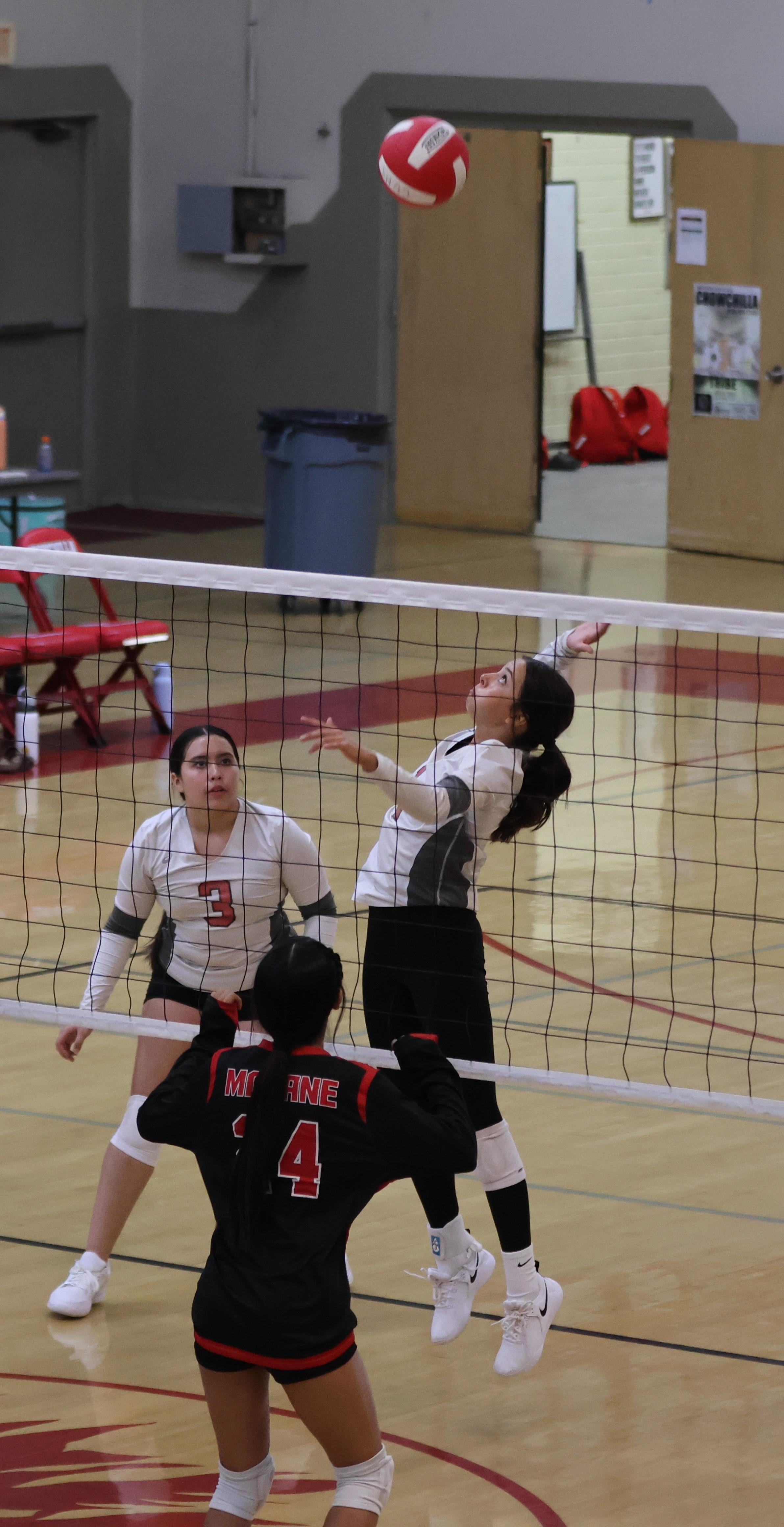 junior varsity girls playing volleyball 118