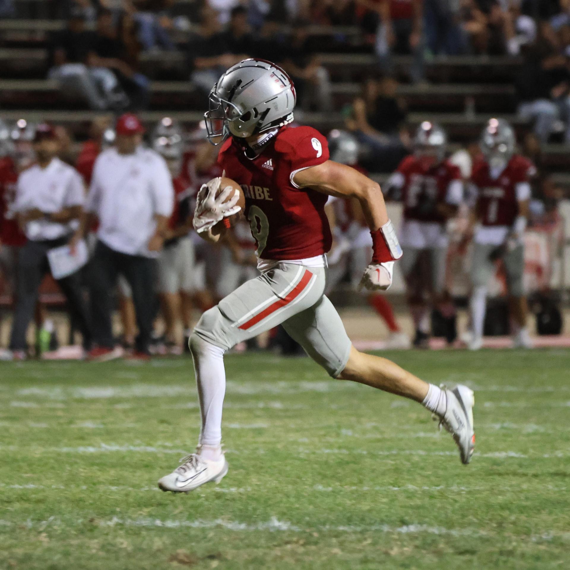 Varsity football players in action against Parlier 50
