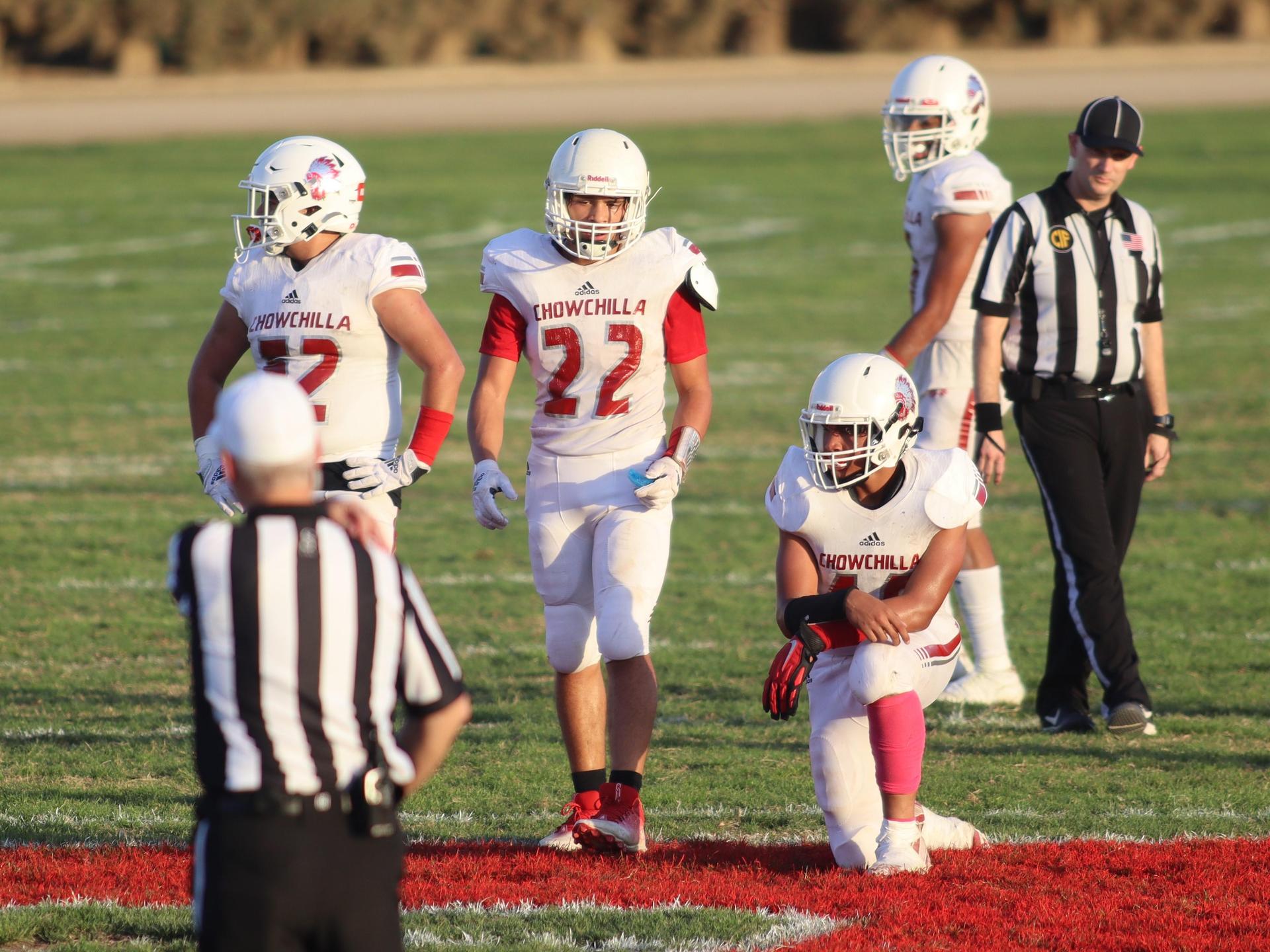 Junior Varsity football players in action against Caruthers