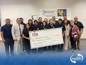 Harmony Magnet Academy students and their coach pose with representatives from Bareng and TCOE, proudly holding a large $1,500 check and certificate after winning first place in the Tulare County Internship Design Challenge.