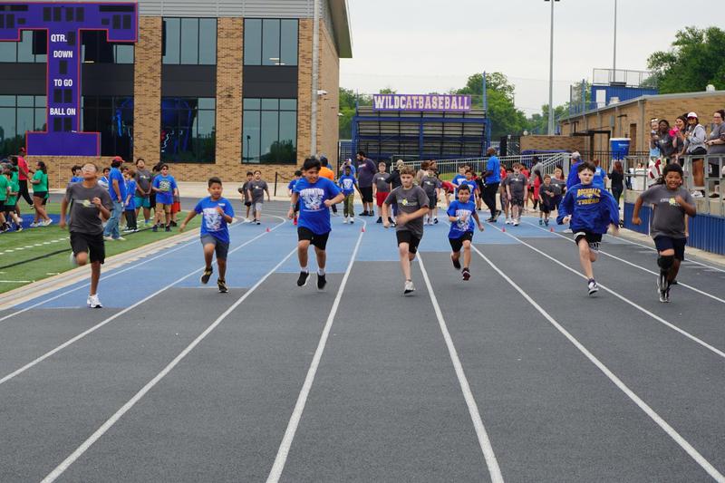 Children race on a track at a school event