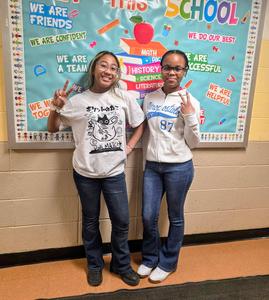 Students twinning together and peace signs