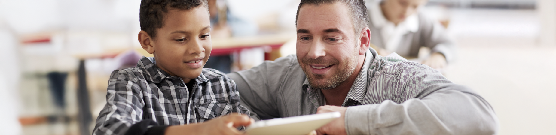 Male teacher tutoring young student