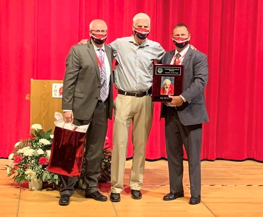 Photo of Mr. Roger Martin, Mr. Jay Muldoon, and Superintendent Billy Smith presenting Mr. Muldoon with plaque for being named Teacher of the Year