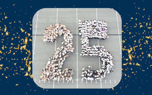 Students from the class of 2025 standing in parking lot in the shape of a 2 and 5. Aerial view.