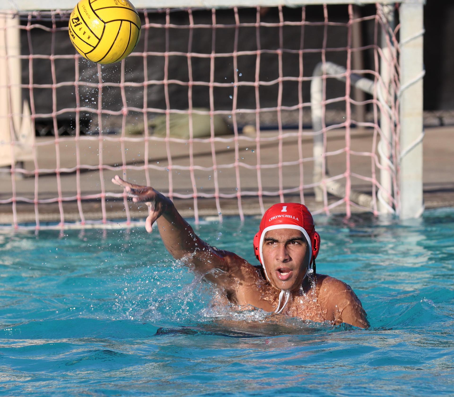 boys water polo players in action against hoover