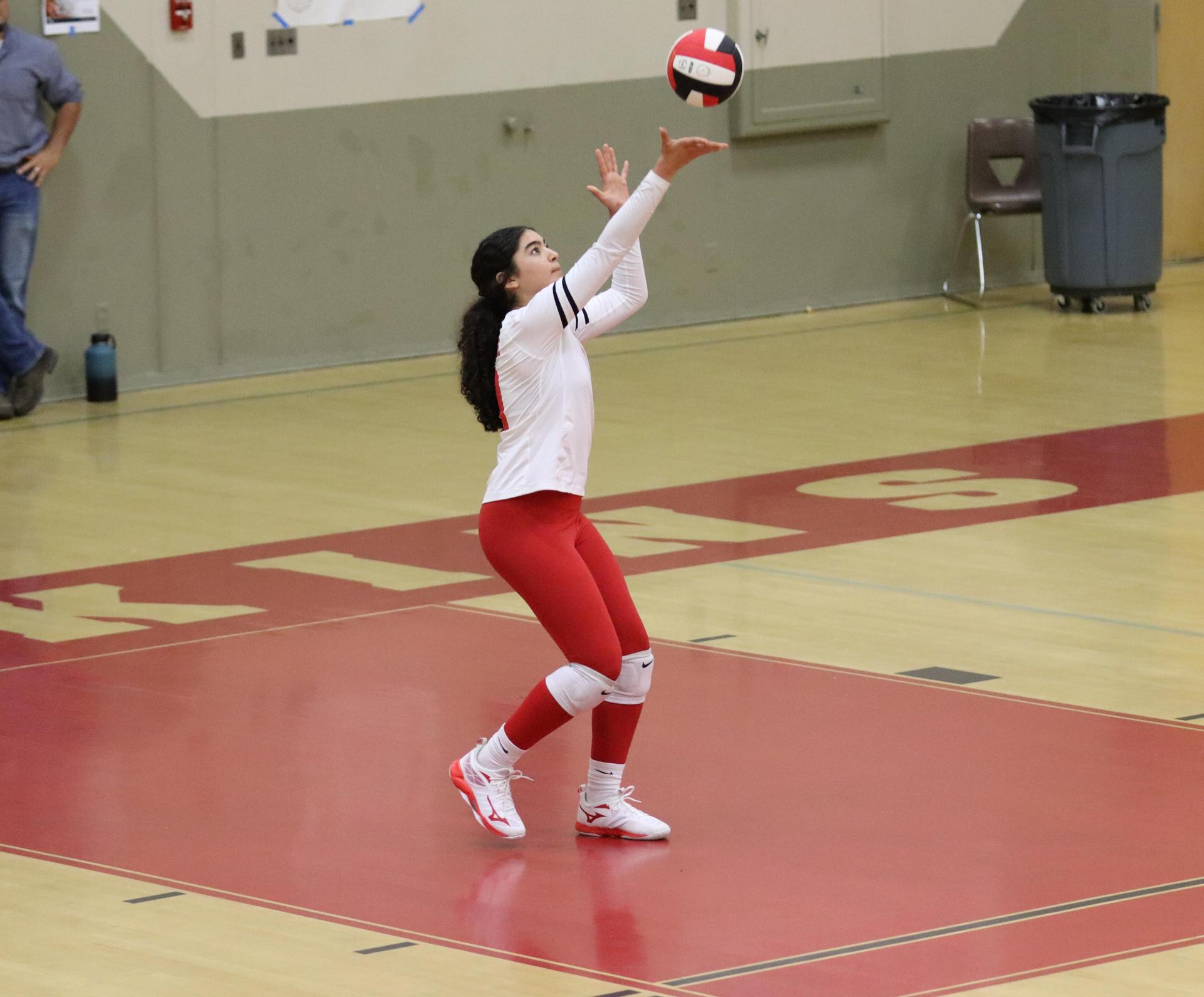 varsity volleyball players in action against liberty