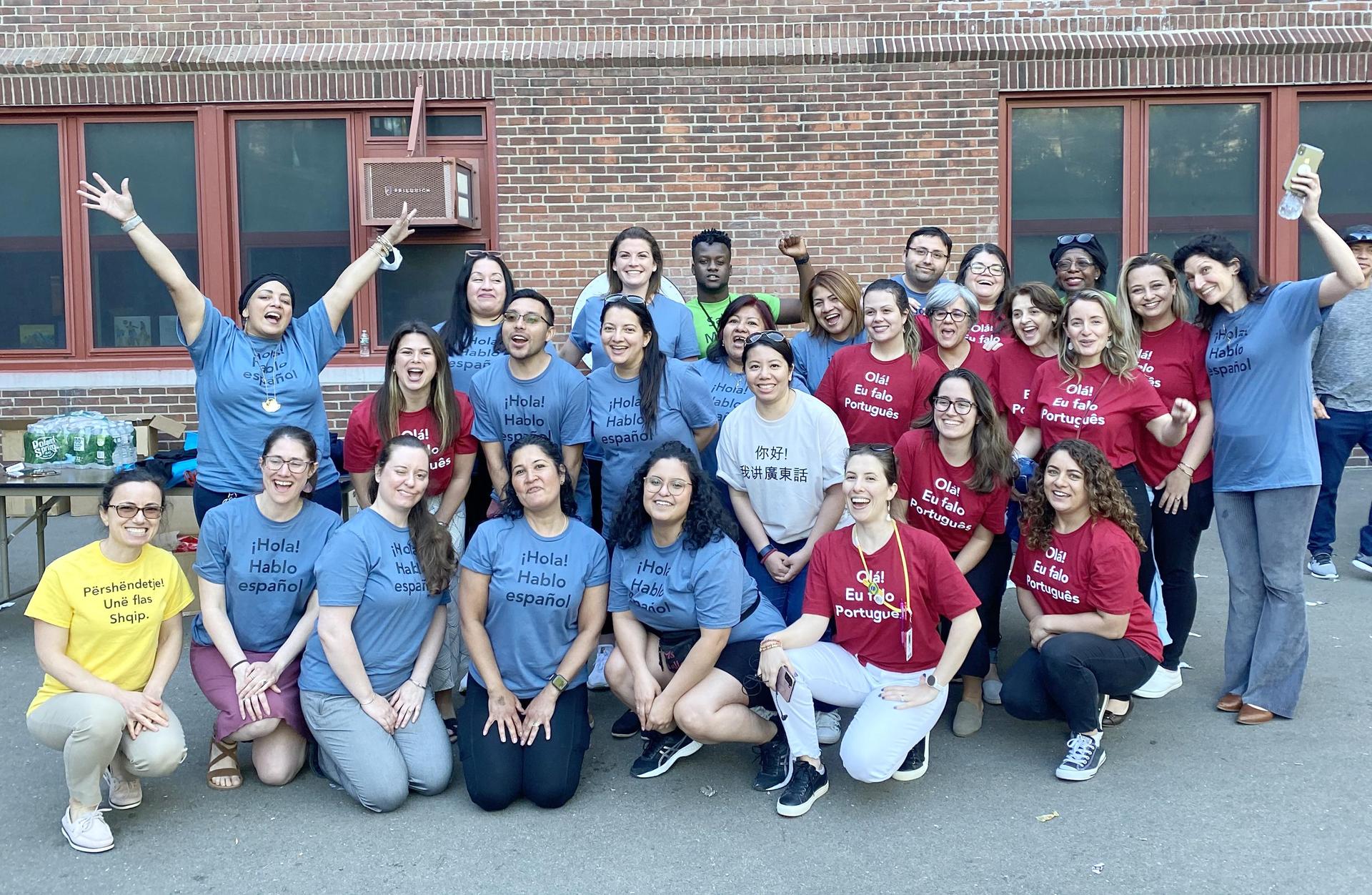 Group photo, informal, educators wearing color-coded T-shirts indicating what foreign language they speak