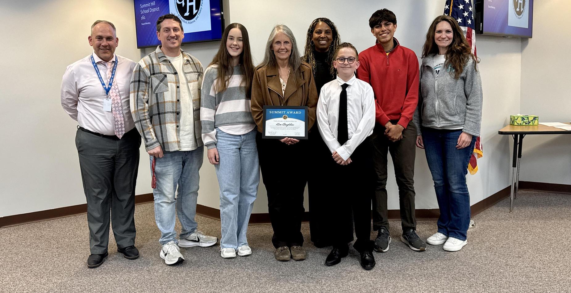 Group photo of May Summit Award winner Kim Coughlin with Summit Hill 161 staff and students after being recognized during the Board of Education meeting.