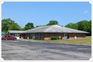 The image is of the brick building located at 266 Warren Street, Madisonville, TN
