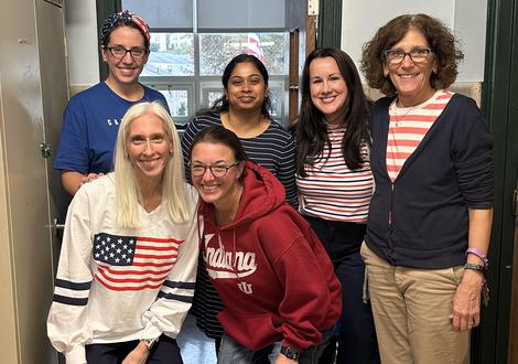 6 adult females wearing different variations of red white and blue