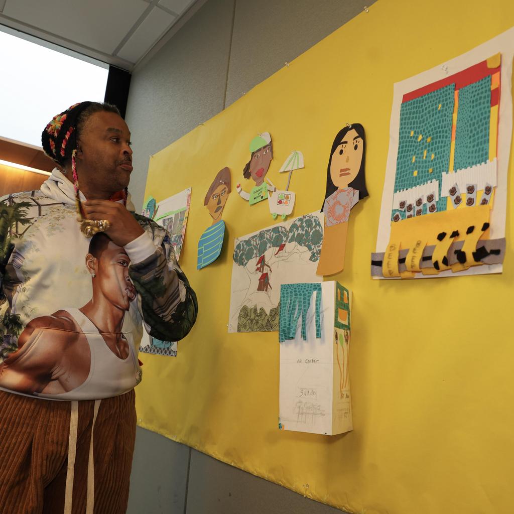 Person standing next to art