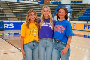 three students pose together