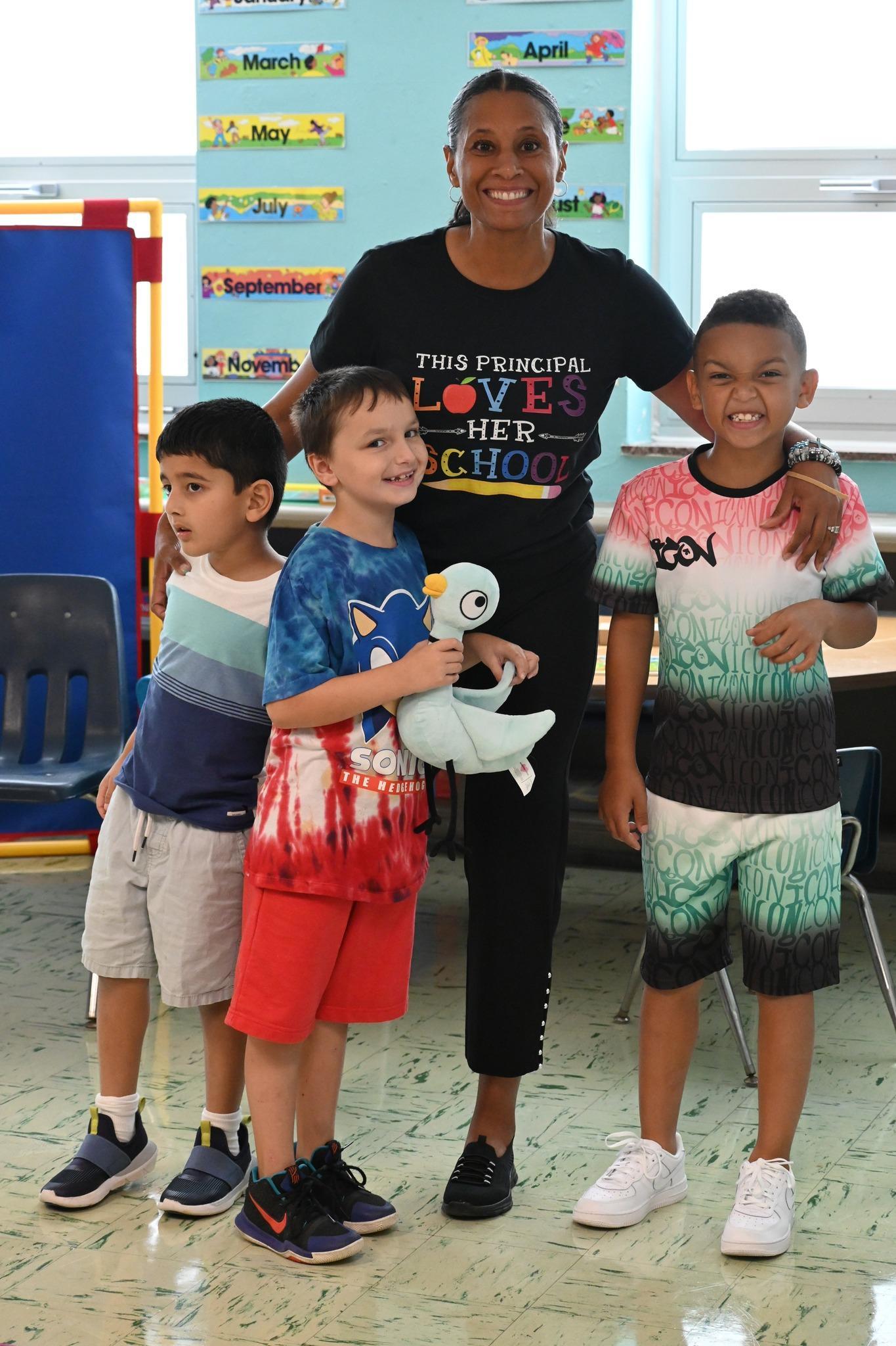 Photo of Principal Denise Hayes from North and three of her students.