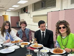 Student actors share a spaghetti dinner.
