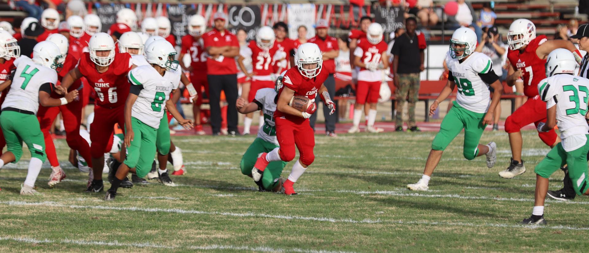  junior varsity football players in action against riverdale