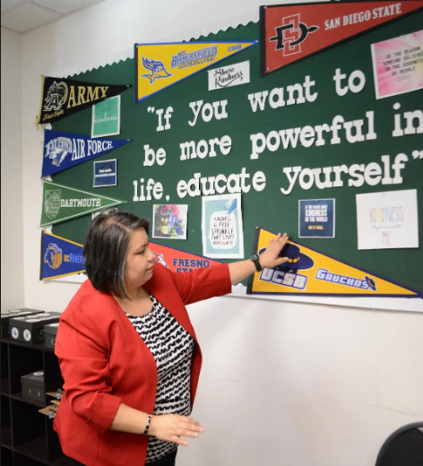 Counselor Ms. Alma showing a wall display