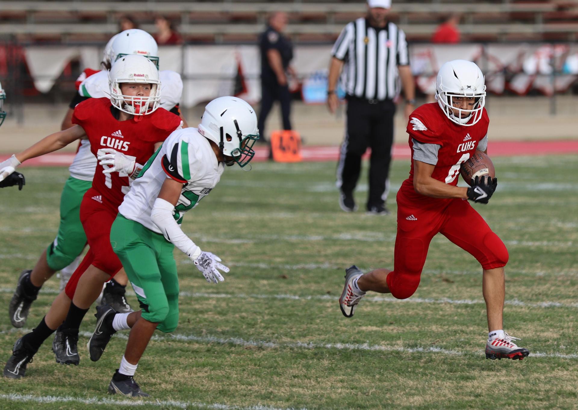  junior varsity football players in action against riverdale