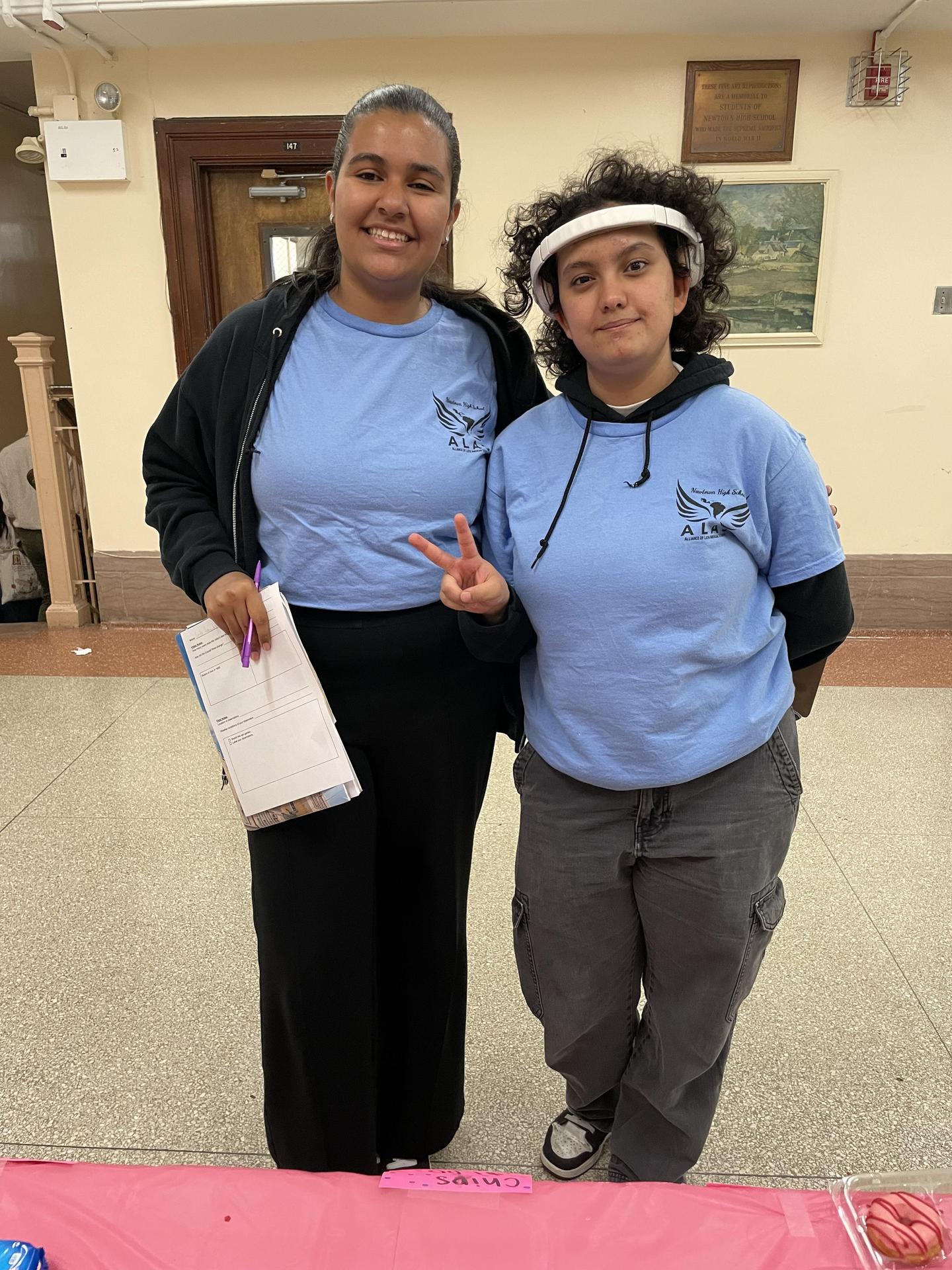 Two students from A.L.A.S. in matching outfits posing.