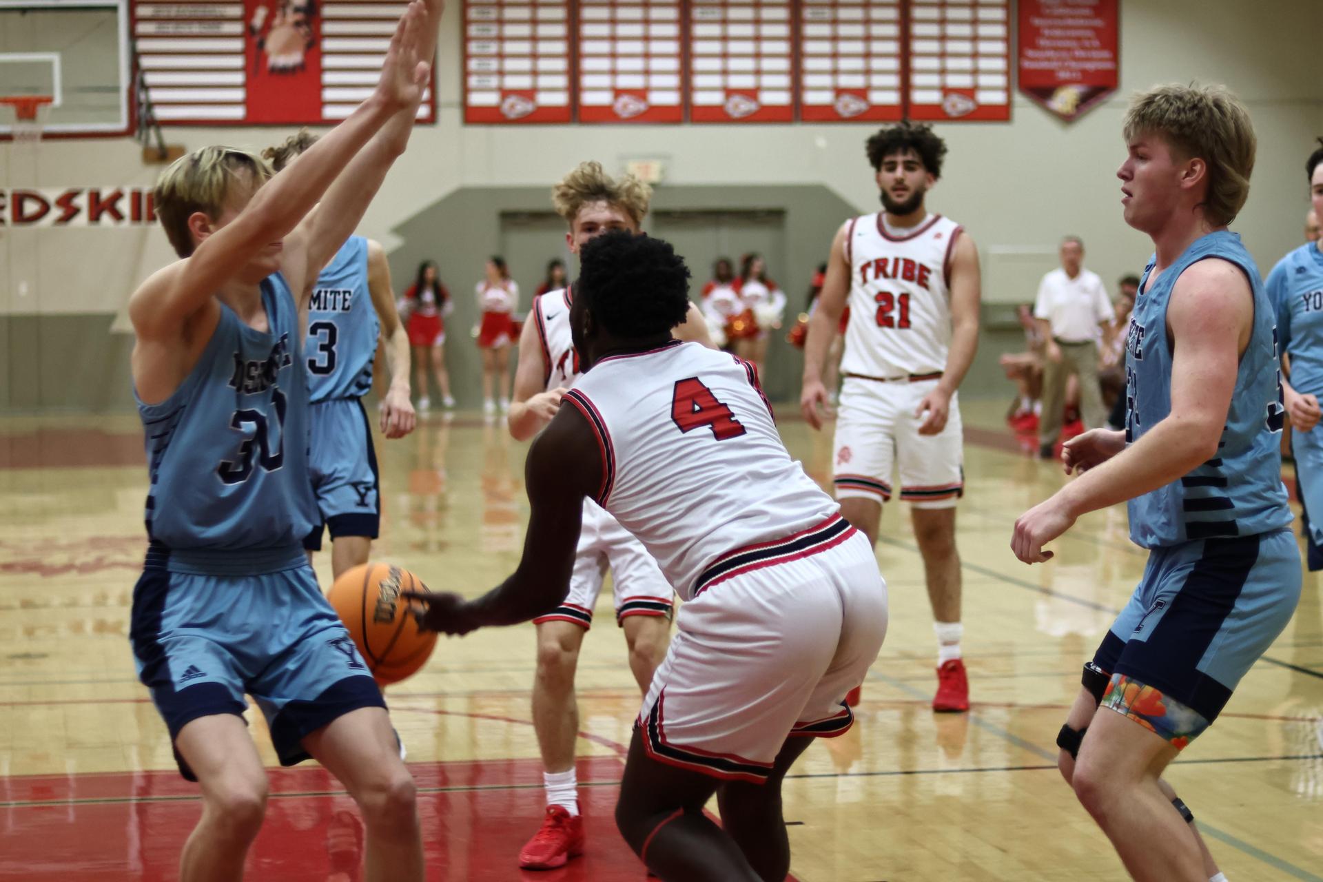 Varsity boys playing basketball against yosemite