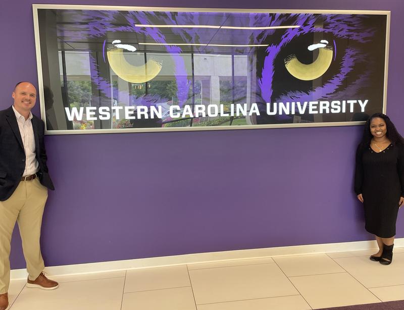 Senior Director of Business and Athletics Steven Jones, left, poses with a representative from Western Carolina University.