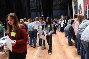 Freshmen girls crowd around tables to get information about local companies
