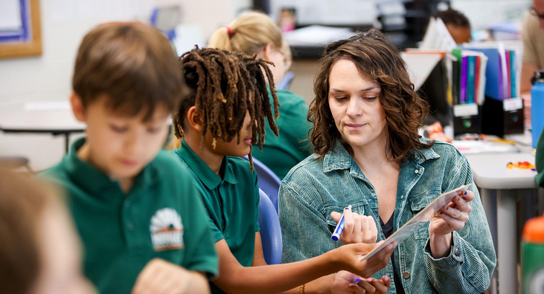 Teacher helping student
