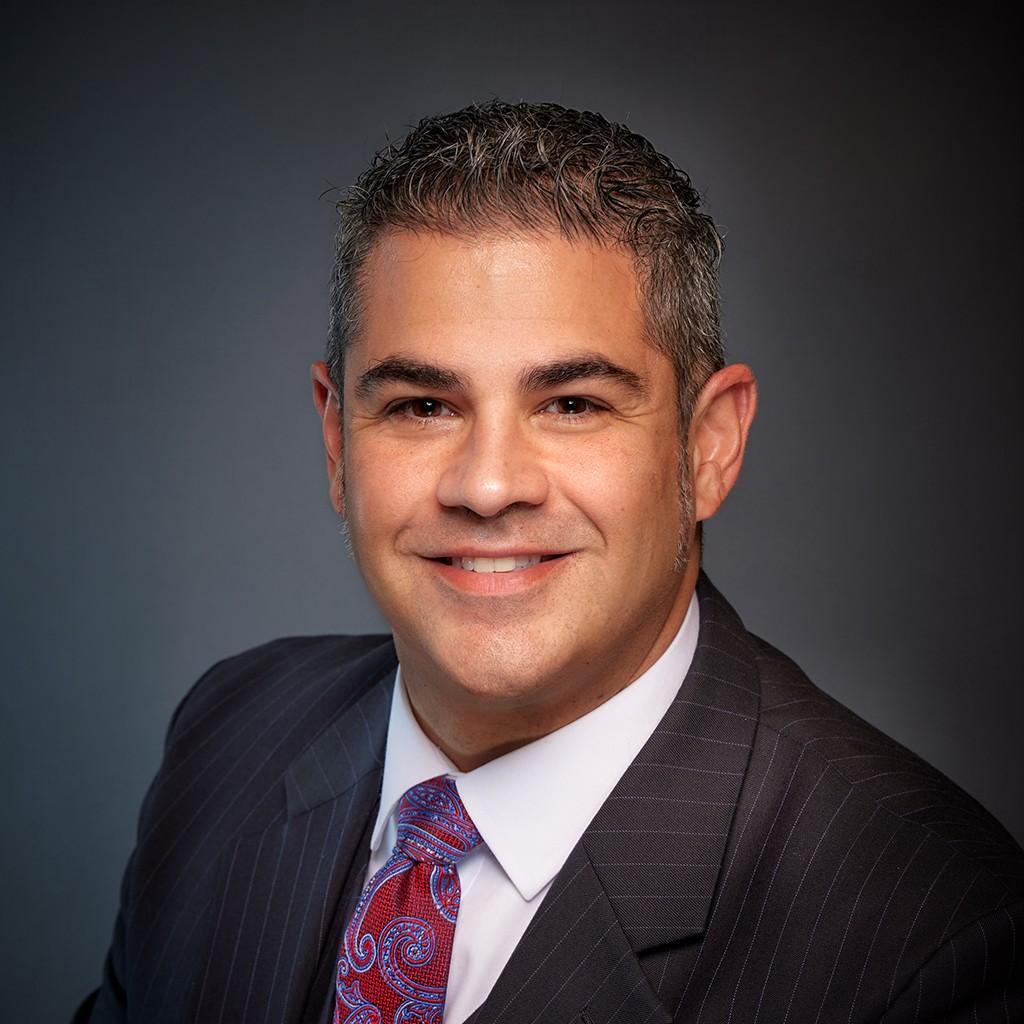 Dr. Alexander Anetakis in a suit and tie.