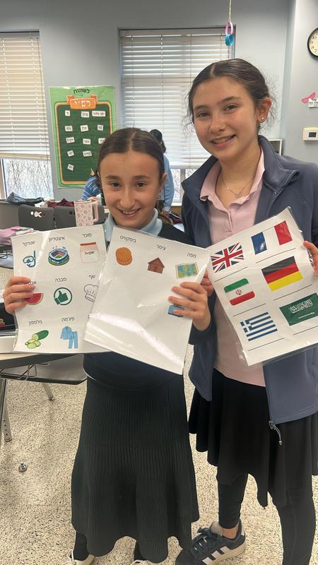 Two girls match words in Ivrit with their linguistic sources.