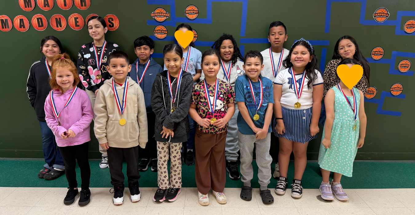 Group of children with medals posing together, smiling in a school setting.