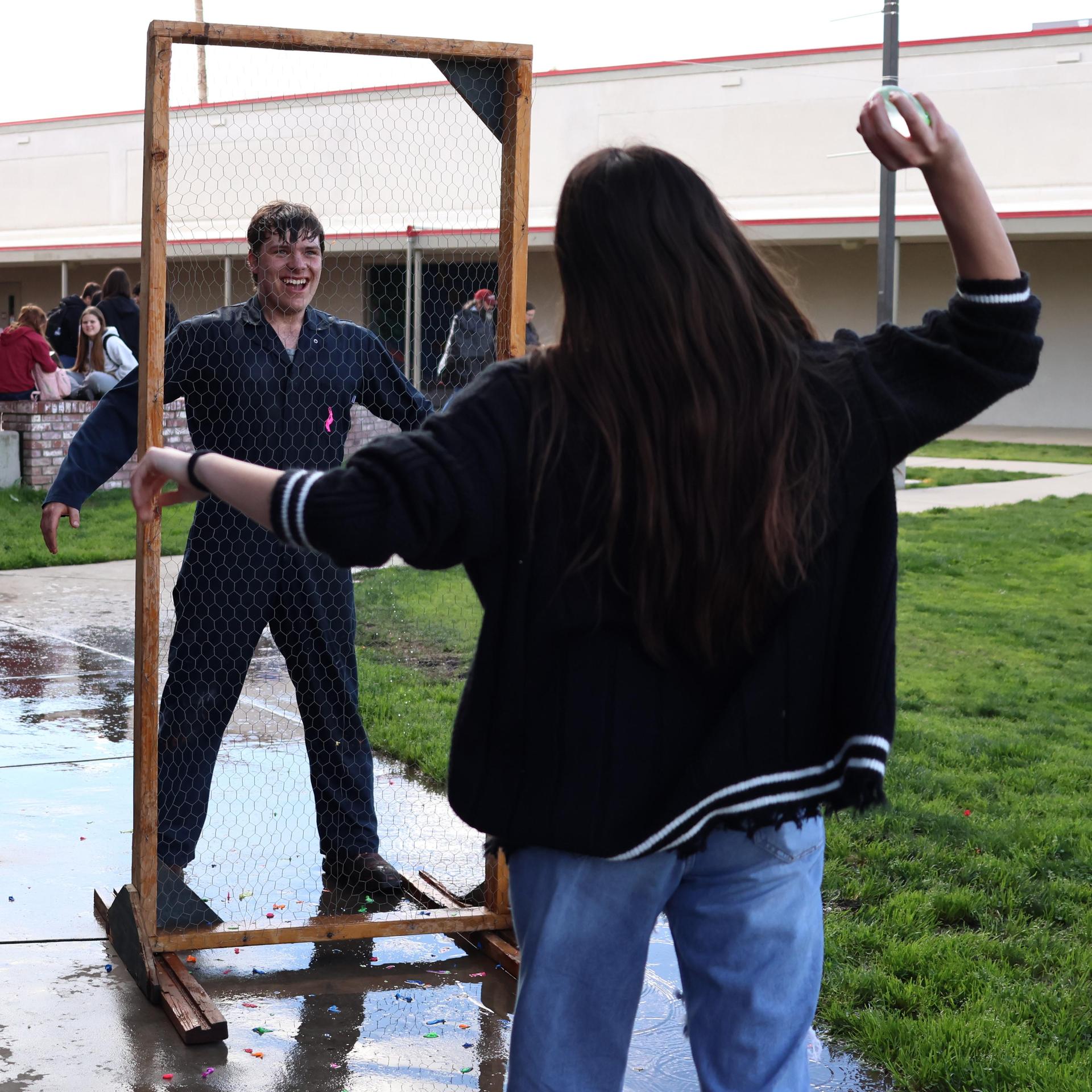 students and staff enjoying the water balloon toss