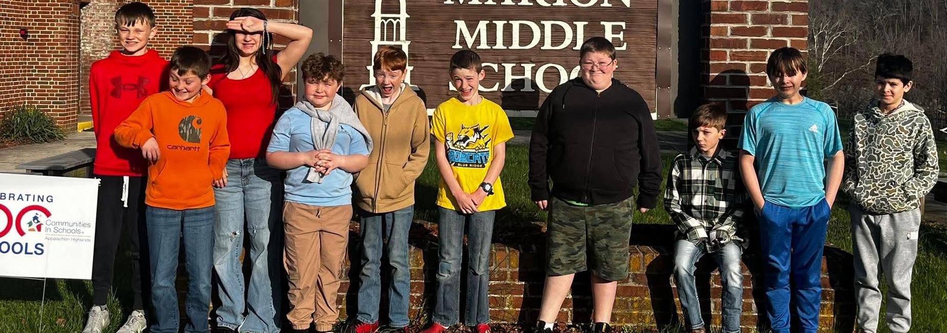 5th grade class lined up in front of visiting middle school sign