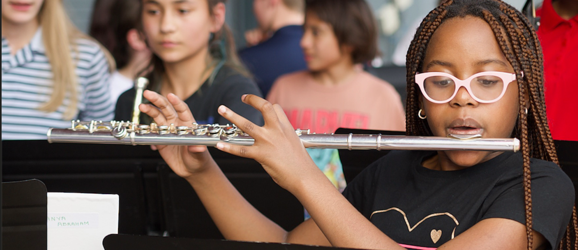 A student practices the flute as they set up for a band performance during Founders Day