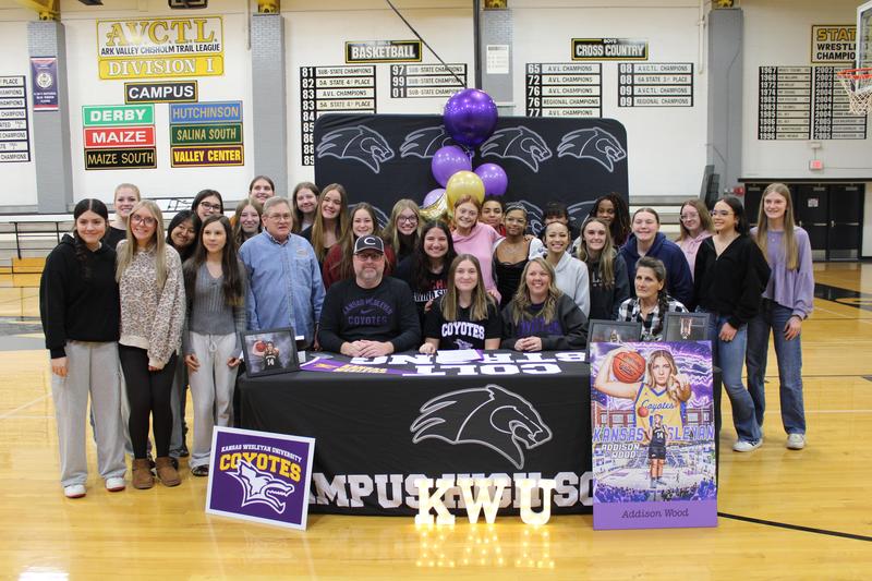 Addison Wood sitting with friends on signing day