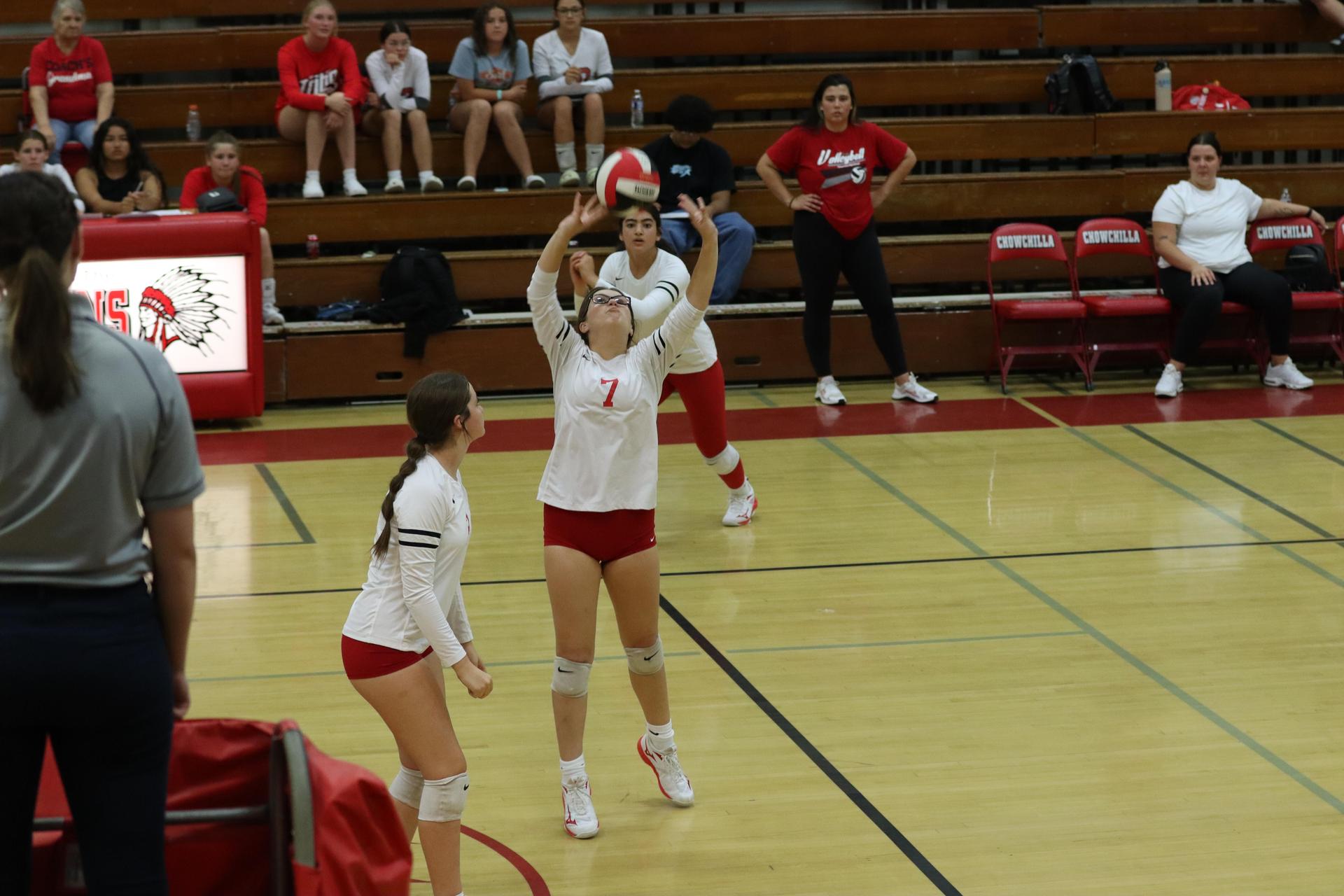 varsity volleyball players in action against liberty