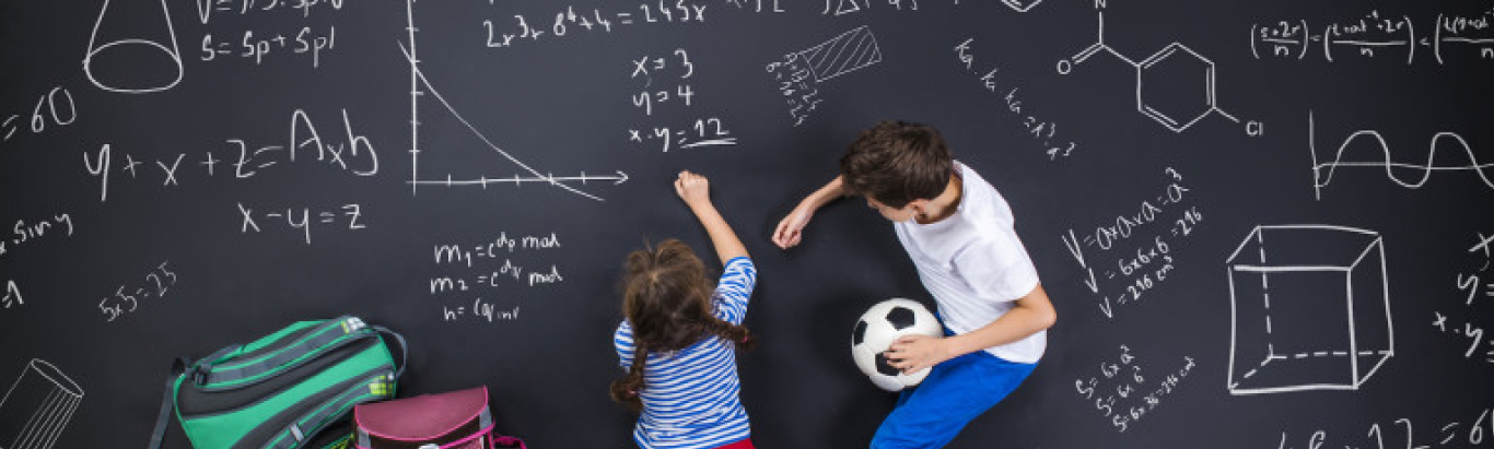Students working math problems on chalkboard